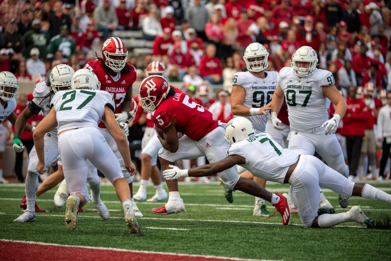 Oct 16, 2021; Bloomington, Indiana, USA; Indiana Hoosiers running back Stephen Carr (5) attempts to push through for a touchdown but falls just short during the second half against the Michigan State Spartans at Memorial Stadium. Spartans win 20-15.  Mandatory Credit: Marc Lebryk-USA TODAY Sports