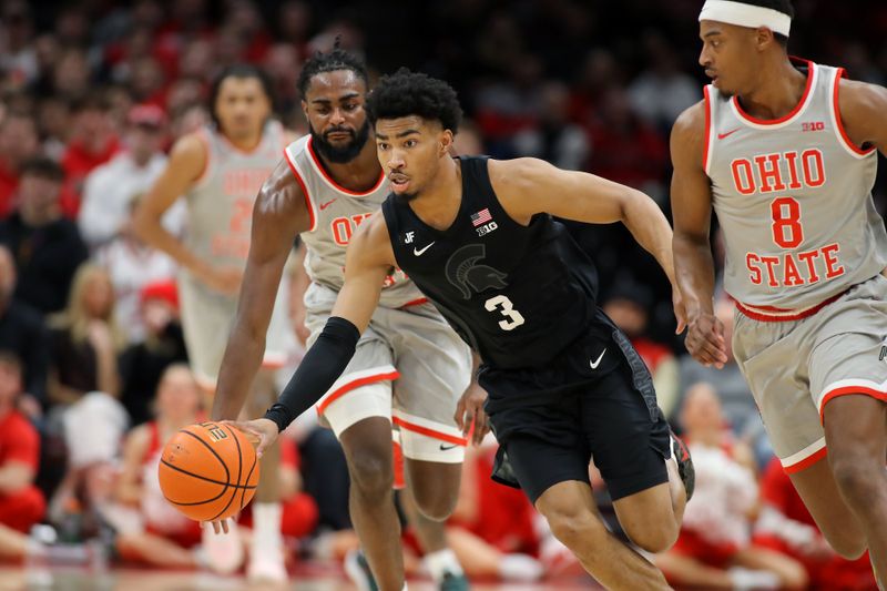 Jan 3, 2025; Columbus, Ohio, USA; Michigan State Spartans guard Jaden Akins (3) steals the ball from Ohio State Buckeyes guard Micah Parrish (8) and guard Evan Mahaffey (12) during the second half at Value City Arena. Mandatory Credit: Joseph Maiorana-Imagn Images