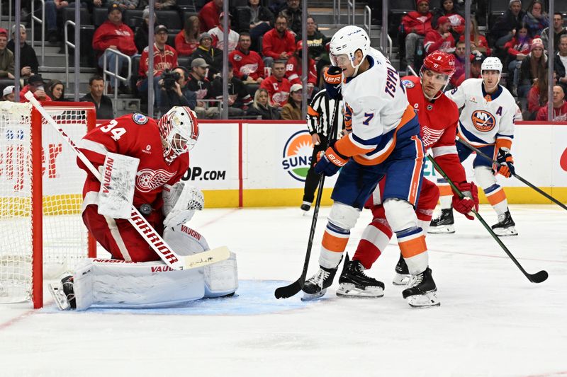 Nov 21, 2024; Detroit, Michigan, USA; Detroit Red Wings goaltender Alex Lyon (34) stops a shot on goal from New York Islanders right wing Maxim Tsyplakov (7) in the third period at Little Caesars Arena. Mandatory Credit: Lon Horwedel-Imagn Images