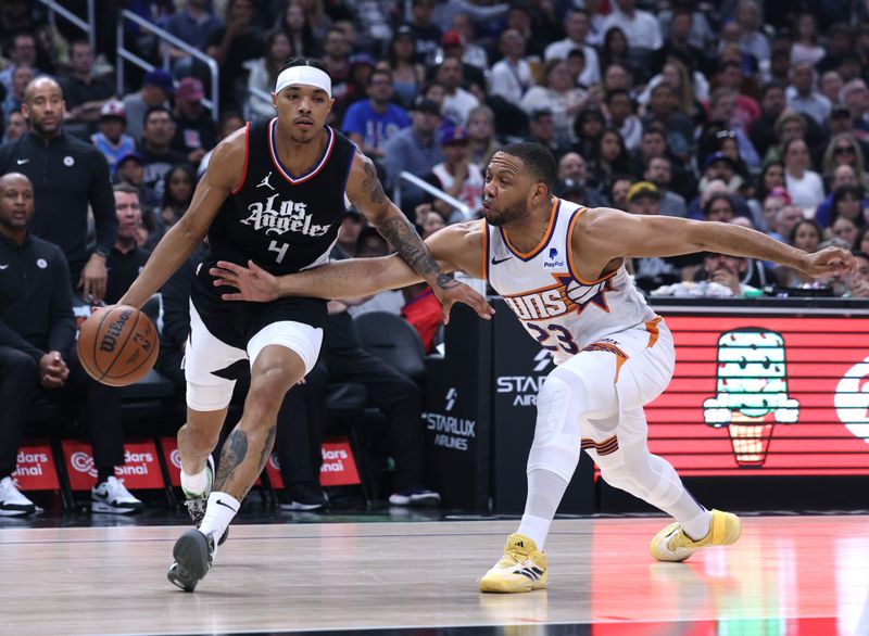 LOS ANGELES, CALIFORNIA - APRIL 10: Brandon Boston Jr. #4 of the LA Clippers drives to the basket past Eric Gordon #23 of the Phoenix Suns during the first half at Crypto.com Arena on April 10, 2024 in Los Angeles, California. User is consenting to the terms and conditions of the Getty Images License Agreement.  (Photo by Harry How/Getty Images)