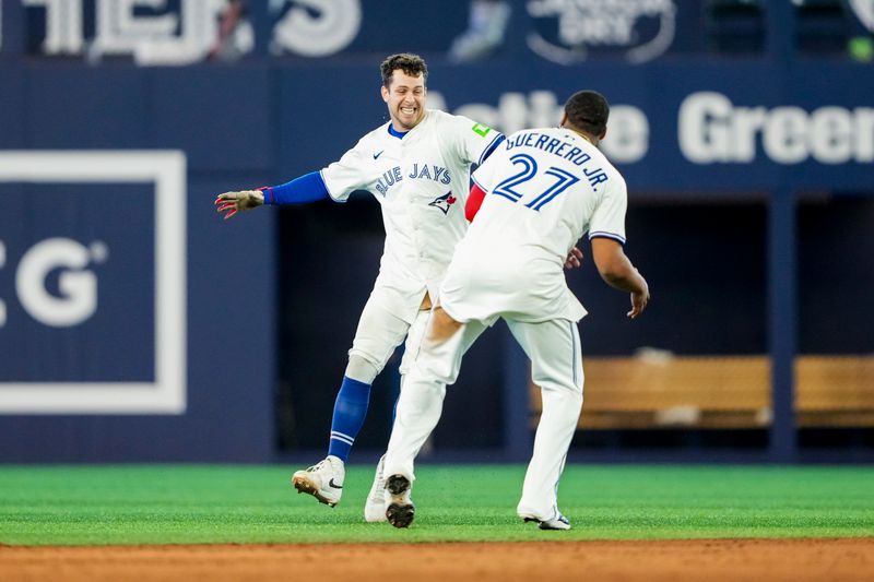 May 17, 2025; Toronto, Ontario, CAN; Toronto Blue Jays third base Ernie Clement (22) celebrates after hitting a walk off single to defeat the Detroit Tigers with first base Vladimir Guerrero Jr. (27) during the ninth inning in their MLB game at Rogers Centre. Mandatory Credit: Kevin Sousa-Imagn Images