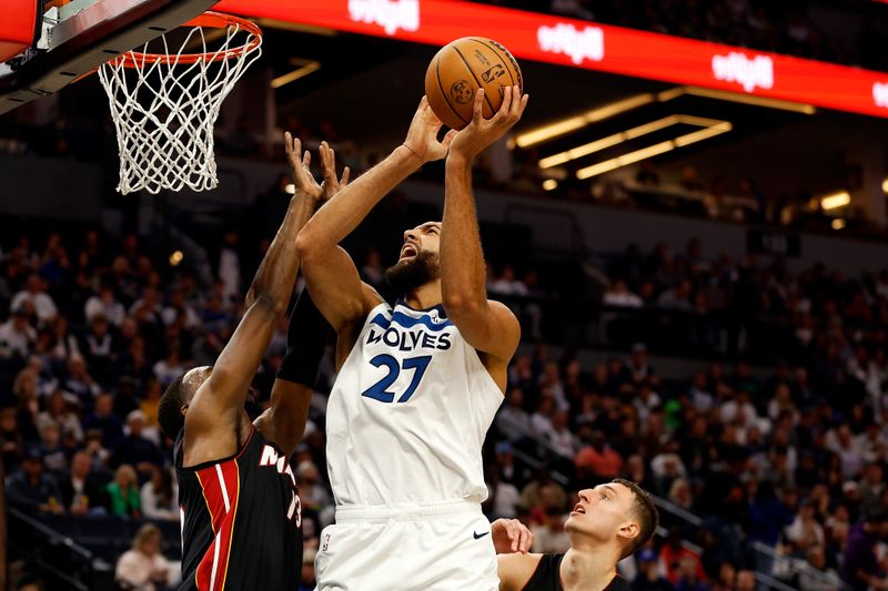 MINNEAPOLIS, MINNESOTA - OCTOBER 28: Rudy Gobert #27 of the Minnesota Timberwolves is fouled by Bam Adebayo #13 of the Miami Heat on a shot in the third quarter at Target Center on October 28, 2023 in Minneapolis, Minnesota. The Timberwolves defeated the Heat 106-90. NOTE TO USER: User expressly acknowledges and agrees that, by downloading and or using this photograph, User is consenting to the terms and conditions of the Getty Images License Agreement. (Photo by David Berding/Getty Images)