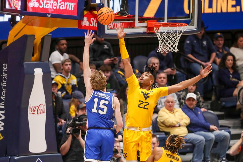 Feb 3, 2024; Morgantown, West Virginia, USA; West Virginia Mountaineers forward Josiah Harris (22) defends Brigham Young Cougars guard Richie Saunders (15) during the first half at WVU Coliseum. Mandatory Credit: Ben Queen-USA TODAY Sports