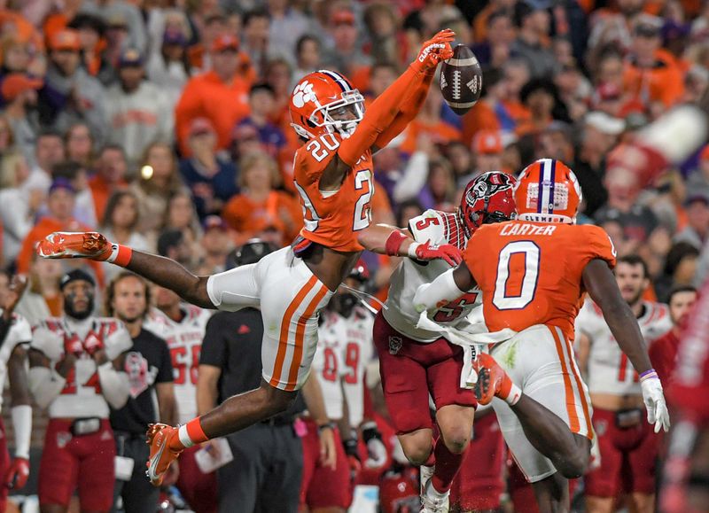 Oct 1, 2022; Clemson, South Carolina, USA; Clemson Tigers cornerback Nate Wiggins (20) breaks up a pass intended for North Carolina State Wolfpack wide receiver Thayer Thomas (5) during the fourth quarter at Memorial Stadium. Mandatory Credit: Ken Ruinard-USA TODAY Sports