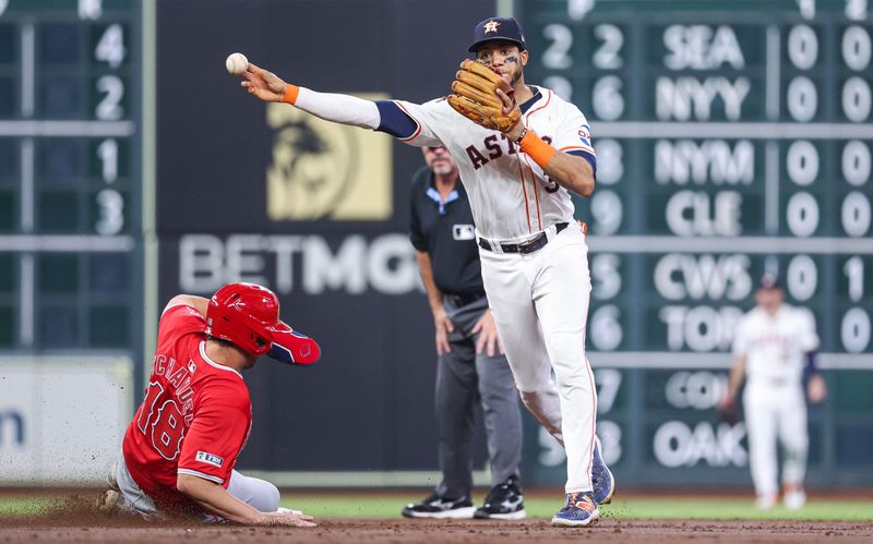 May 21, 2024; Houston, Texas, USA; Los Angeles Angels first baseman Nolan Schanuel (18) is out as Houston Astros shortstop Jeremy Pena (3) throws to first base during the third inning at Minute Maid Park. Mandatory Credit: Troy Taormina-USA TODAY Sports