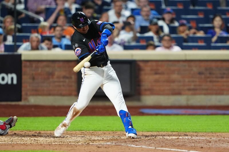 Jul 10, 2024; New York City, New York, USA; New York Mets second baseman Jose Iglesias (11) hits a RBI single against the Washington Nationals during the sixth inning at Citi Field. Mandatory Credit: Gregory Fisher-USA TODAY Sports