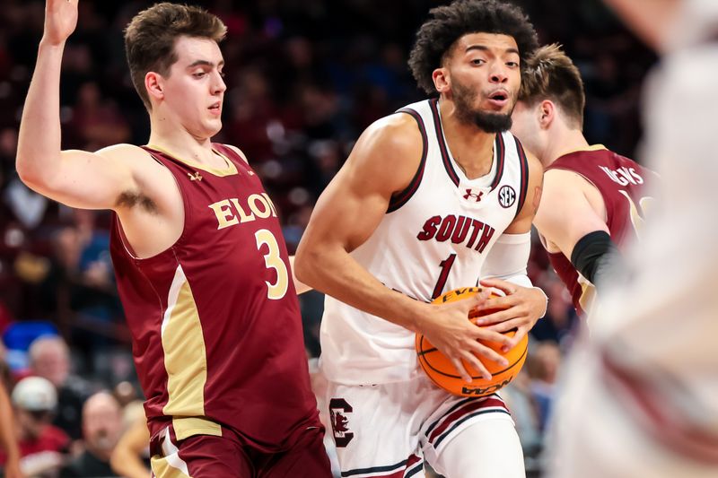 Dec 22, 2023; Columbia, South Carolina, USA; South Carolina Gamecocks guard Jacobi Wright (1) drives around Elon Phoenix guard Max Mackinnon (3) in the second half at Colonial Life Arena. Mandatory Credit: Jeff Blake-USA TODAY Sports