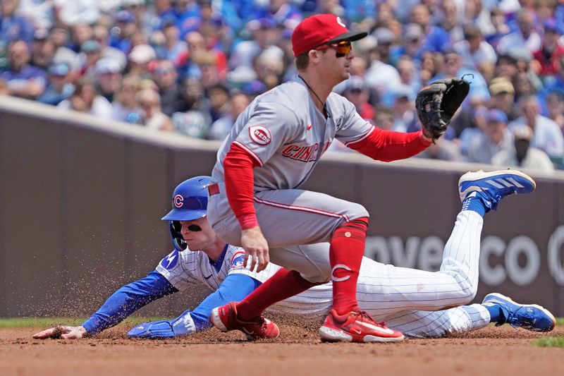 Jun 1, 2025; Chicago, Illinois, USA; Chicago Cubs outfielder Pete Crow-Armstrong (4) steals second base as Cincinnati Reds second base Matt McLain (9) takes a late throw during the first inning at Wrigley Field. Mandatory Credit: David Banks-Imagn Images