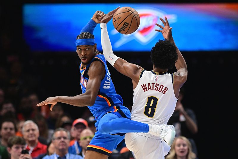 OKLAHOMA CITY, OKLAHOMA - JANUARY 31: Shai Gilgeous-Alexander #2 of the Oklahoma City Thunder gets tangled up with Peyton Watson #8 of the Denver Nuggets in the first half at Paycom Center on January 31, 2024 in Oklahoma City, Oklahoma. NOTE TO USER: User expressly acknowledges and agrees that, by downloading and or using this Photograph, user is consenting to the terms and conditions of the Getty Images License Agreement. (Photo by Joshua Gateley/Getty Images)