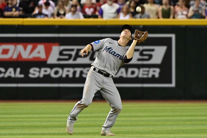 May 8, 2023; Phoenix, Arizona, USA;  Miami Marlins shortstop Joey Wendle (18) catches a fly ball in the eighth inning against the Arizona Diamondbacks at Chase Field. Mandatory Credit: Matt Kartozian-USA TODAY Sports