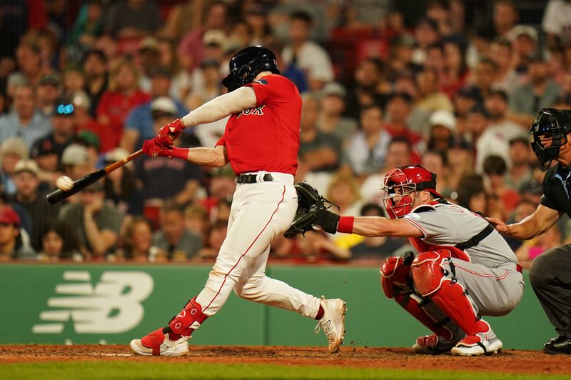 Jun 1, 2023; Boston, Massachusetts, USA; Boston Red Sox catcher Connor Wong (12) hits a two run home run against the Cincinnati Redsin the eighth inning at Fenway Park. Mandatory Credit: David Butler II-USA TODAY Sports