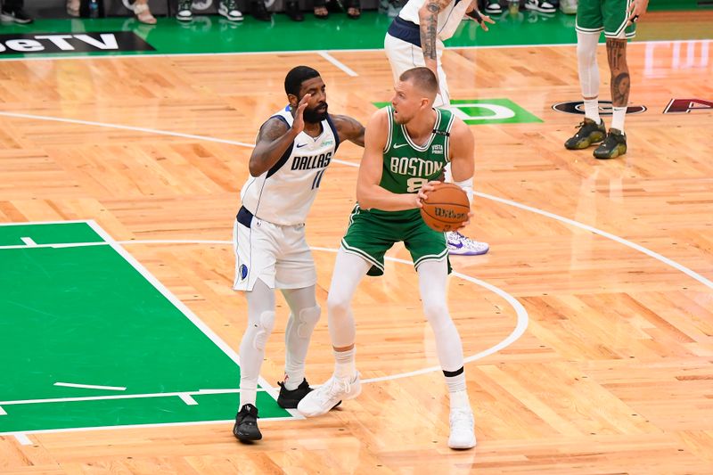 BOSTON, MA - JUNE 17: Kristaps Porzingis #8 of the Boston Celtics handles the ball during the game against the Dallas Mavericks during Game 5 of the 2024 NBA Finals on June 17, 2024 at the TD Garden in Boston, Massachusetts. NOTE TO USER: User expressly acknowledges and agrees that, by downloading and or using this photograph, User is consenting to the terms and conditions of the Getty Images License Agreement. Mandatory Copyright Notice: Copyright 2024 NBAE  (Photo by Brian Babineau/NBAE via Getty Images)