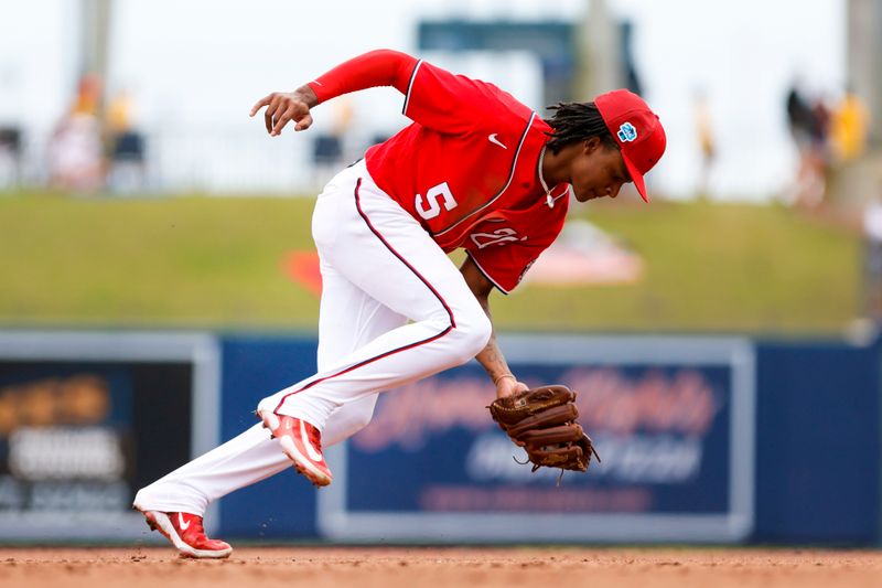 Mar 19, 2023; West Palm Beach, Florida, USA; Washington Nationals shortstop CJ Abrams (5) catches a ground ball prior to throwing to first base to retire Detroit Tigers shortstop Zack Short (not pictured) during the fifth inning at The Ballpark of the Palm Beaches. Mandatory Credit: Sam Navarro-USA TODAY Sports