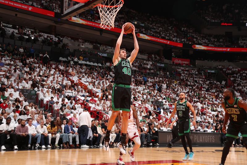 MIAMI, FL - APRIL 27: Luke Kornet #40 of the Boston Celtics grabs the rebound during the game against the Miami Heat during Round 1 Game 3 of the 2024 NBA Playoffs on April 27, 2024 at Kaseya Center in Miami, Florida. NOTE TO USER: User expressly acknowledges and agrees that, by downloading and or using this Photograph, user is consenting to the terms and conditions of the Getty Images License Agreement. Mandatory Copyright Notice: Copyright 2024 NBAE (Photo by Issac Baldizon/NBAE via Getty Images)