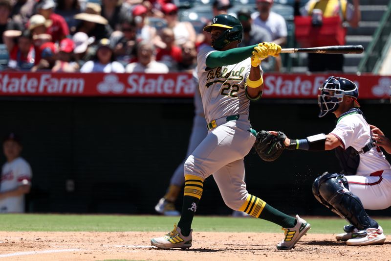 Jul 28, 2024; Anaheim, California, USA;  Oakland Athletics left fielder Miguel Andujar (22) hits an RBI fielder's choice during the third inning against the Los Angeles Angels at Angel Stadium. Mandatory Credit: Kiyoshi Mio-USA TODAY Sports