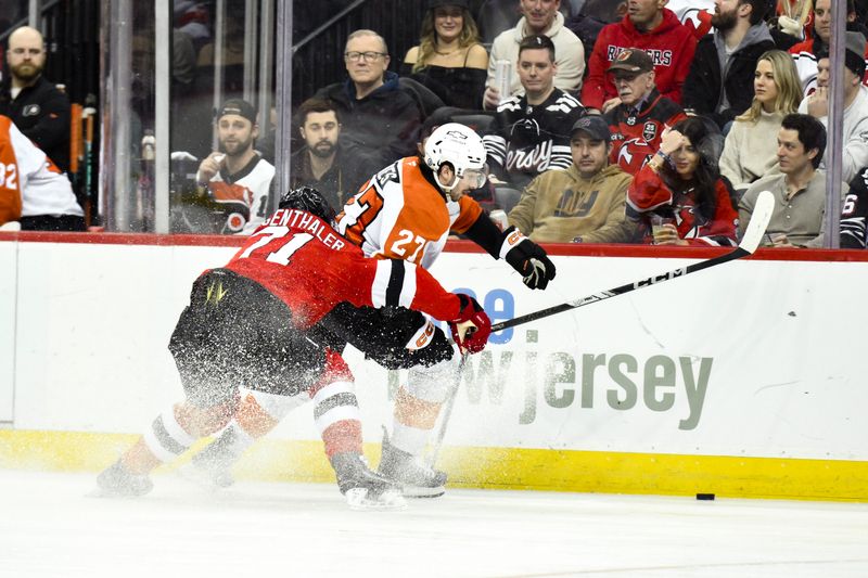 Jan 29, 2025; Newark, New Jersey, USA; Philadelphia Flyers left wing Noah Cates (27) moves the puck past New Jersey Devils defenseman Jonas Siegenthaler (71) during the second period at Prudential Center. Mandatory Credit: John Jones-Imagn Images