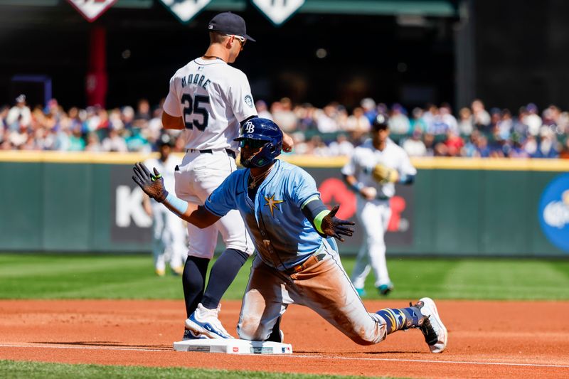 Aug 28, 2024; Seattle, Washington, USA; Tampa Bay Rays third baseman Junior Caminero (13) reacts after hitting a triple against the Seattle Mariners during the first inning at T-Mobile Park. Mandatory Credit: Joe Nicholson-USA TODAY Sports