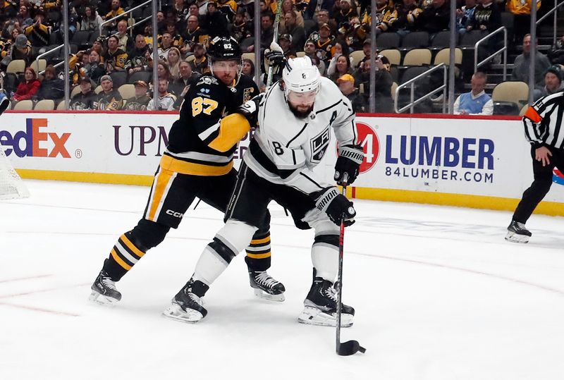 Feb 18, 2024; Pittsburgh, Pennsylvania, USA;  Los Angeles Kings defenseman Drew Doughty (8) moves the puck against pressure from Pittsburgh Penguins center Sidney Crosby (87) /dd3p/ at PPG Paints Arena.  Los Angeles won 2-1.Mandatory Credit: Charles LeClaire-USA TODAY Sports