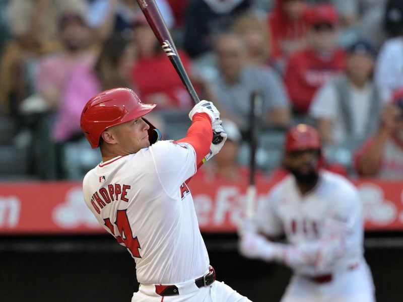 May 30, 2024; Anaheim, California, USA;  Los Angeles Angels catcher Logan O'Hoppe (14) hits a solo home run in the first inning against the New York Yankees at Angel Stadium. Mandatory Credit: Jayne Kamin-Oncea-USA TODAY Sports