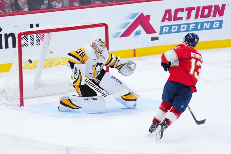 Jan 3, 2025; Sunrise, Florida, USA; Florida Panthers center Sam Reinhart (13) scores against Pittsburgh Penguins goaltender Tristan Jarry (35) during a shootout at Amerant Bank Arena. Mandatory Credit: Rich Storry-Imagn Images