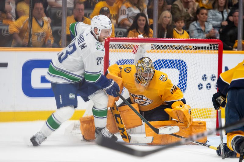 Apr 28, 2024; Nashville, Tennessee, USA; Nashville Predators goaltender Juuse Saros (74) blocks the shot ion Vancouver Canucks center Elias Lindholm (23) during the third period in game four of the first round of the 2024 Stanley Cup Playoffs at Bridgestone Arena. Mandatory Credit: Steve Roberts-USA TODAY Sports