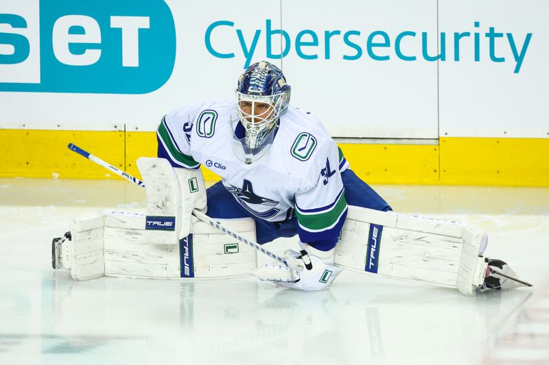 Mar 28, 2026; Calgary, Alberta, CAN; Vancouver Canucks goaltender Kevin Lankinen (32) during the warmup period against the Calgary Flames at Scotiabank Saddledome. Mandatory Credit: Sergei Belski-Imagn Images