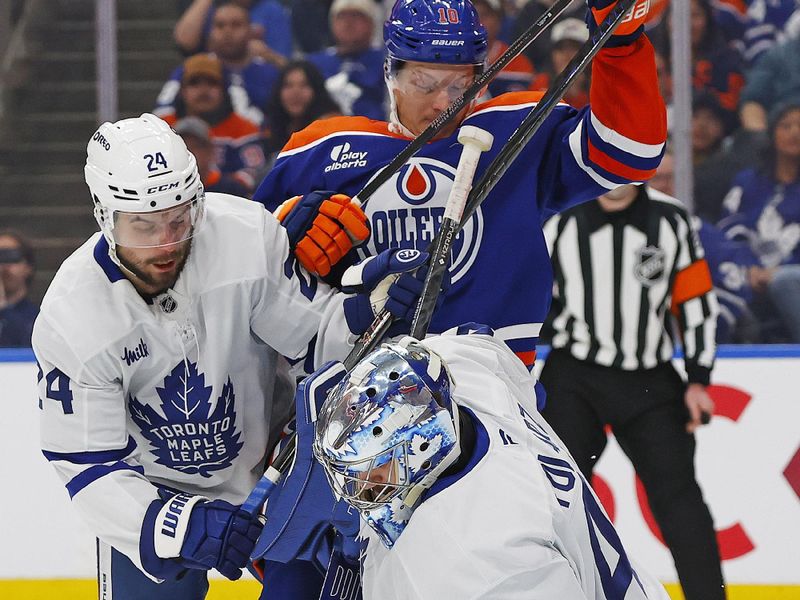 Feb 3, 2026; Edmonton, Alberta, CAN; Edmonton Oilers forward Trent Frederic (10) and Toronto Maple Leafs forward Scott Laughton (24) battle for a loose puck in front of goaltender Anthony Stolarz (41) during the first period at Rogers Place. Mandatory Credit: Perry Nelson-Imagn Images
