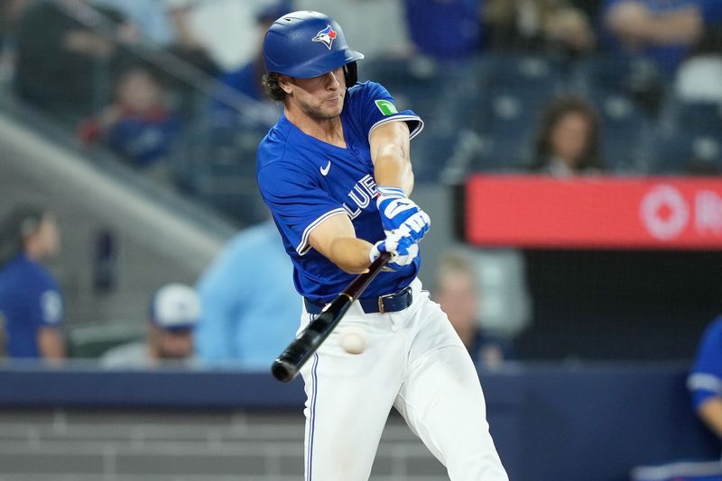 Apr 14, 2024; Toronto, Ontario, CAN; Toronto Blue Jays third baseman Ernie Clement (28) singles against the Colorado Rockies during the sixth inning at Rogers Centre. Mandatory Credit: John E. Sokolowski-USA TODAY Sports