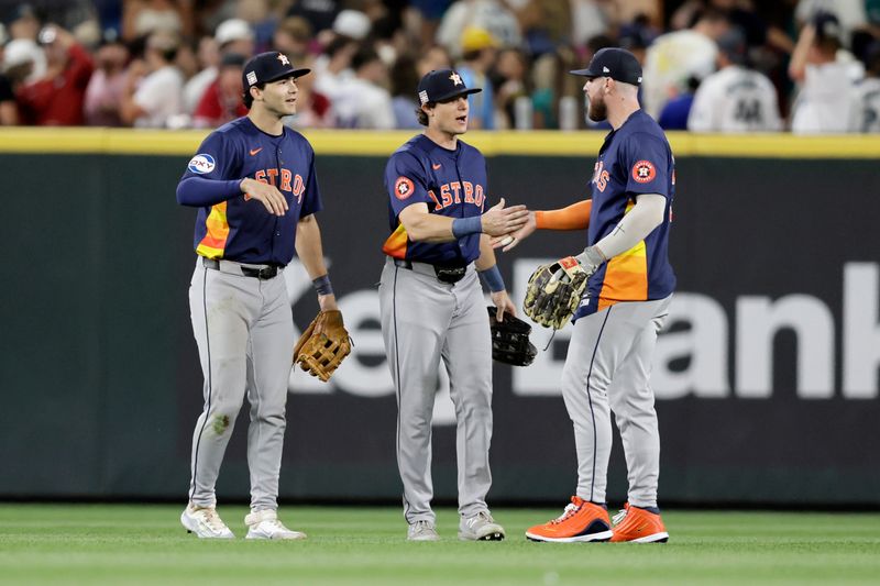 Jul 20, 2024; Seattle, Washington, USA; Houston Astros left fielder Joey Loperfido (left) and center fielder Jake Meyers (6) and right fielder Trey Cabbage (right) celebrate after defeating the Seattle Mariners at T-Mobile Park. Mandatory Credit: John Froschauer-USA TODAY Sports