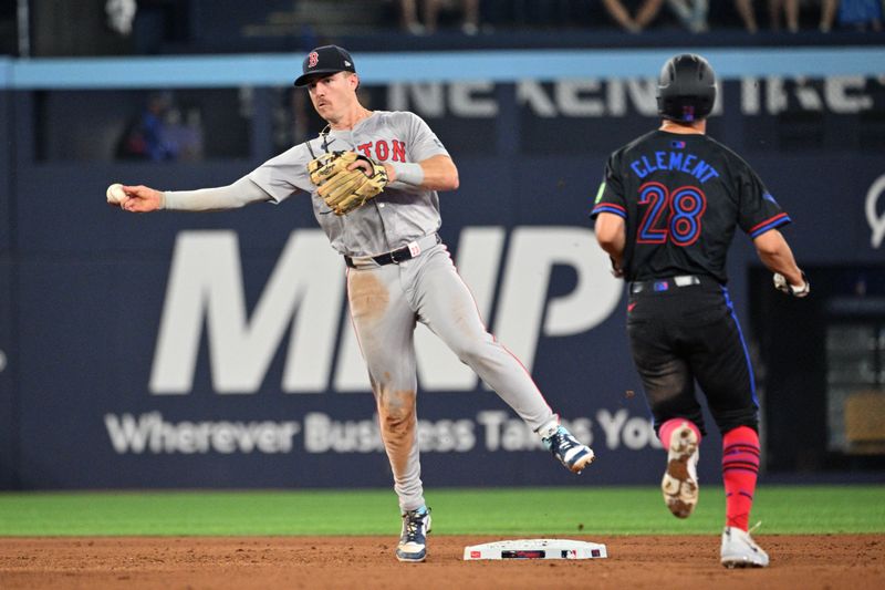 Jun 17, 2024; Toronto, Ontario, CAN;  Boston Red Sox shortstop Romy Gonzalez (23) throws to first base for a double play after forcing out Toronto Blue Jays third baseman Ernie Clement (28) in the seventh inning at Rogers Centre. Mandatory Credit: Dan Hamilton-USA TODAY Sports