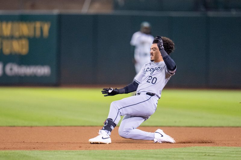 Aug 5, 2024; Oakland, California, USA;  Chicago White Sox third baseman Miguel Vargas (20) slides into second against the Oakland Athletics during the eighth inning at Oakland-Alameda County Coliseum. Mandatory Credit: Neville E. Guard-USA TODAY Sports