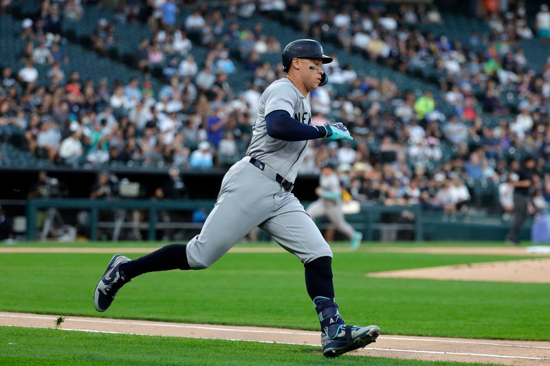 Aug 12, 2024; Chicago, Illinois, USA; New York Yankees outfielder Aaron Judge (99) runs to first base after hitting a RBI double against the Chicago White Sox during the first inning at Guaranteed Rate Field. Mandatory Credit: Kamil Krzaczynski-USA TODAY Sports