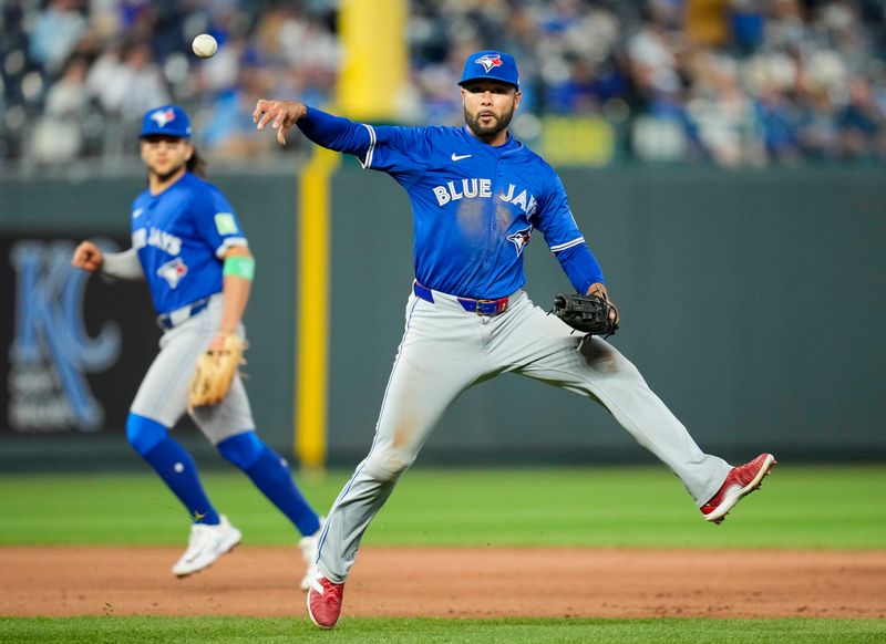 Apr 23, 2024; Kansas City, Missouri, USA; Toronto Blue Jays third base Isiah Kiner-Falefa (7) throws to first base during the fifth inning against the Kansas City Royals at Kauffman Stadium. Mandatory Credit: Jay Biggerstaff-USA TODAY Sports