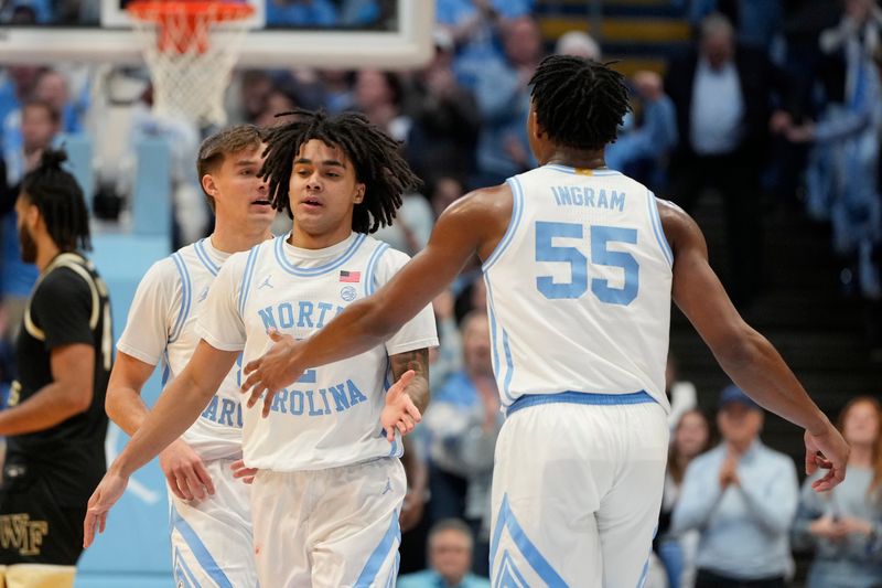 Jan 22, 2024; Chapel Hill, North Carolina, USA;  North Carolina Tar Heels guard Elliot Cadeau (2) with forward Harrison Ingram (55) in the first half at Dean E. Smith Center. Mandatory Credit: Bob Donnan-USA TODAY Sports