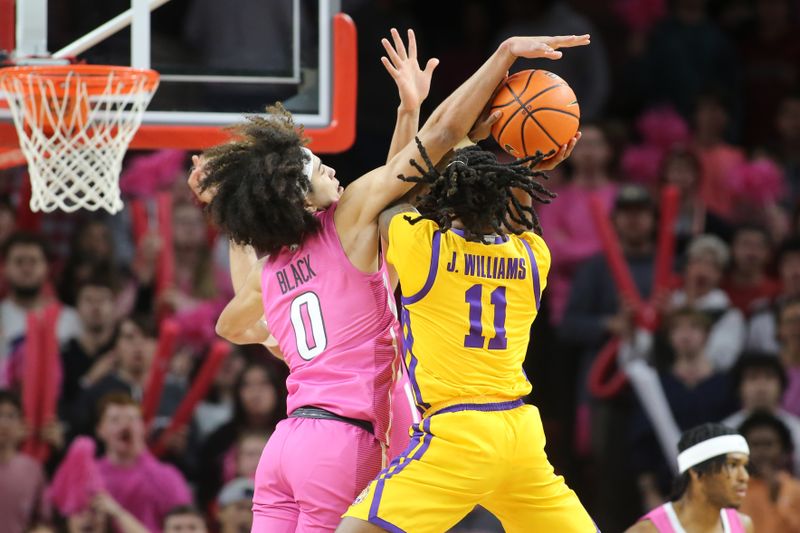 Jan 24, 2023; Fayetteville, Arkansas, USA; Arkansas Razorbacks guard Anthony Black (0) fouls LSU Tigers guard Justice Williams (11) during the first half at Bud Walton Arena. Mandatory Credit: Nelson Chenault-USA TODAY Sports