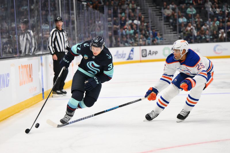 Oct 2, 2024; Seattle, Washington, USA; Seattle Kraken center Yanni Gourde (37) advances the puck while defended by Edmonton Oilers defenseman Darnell Nurse (25)  during the third period at Climate Pledge Arena. Mandatory Credit: Steven Bisig-Imagn Images