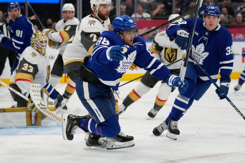 Nov 20, 2024; Toronto, Ontario, CAN; Toronto Maple Leafs forward William Nylander (88) is tripped by Vegas Golden Knights defenseman Alex Pietrangelo (7) during the third period at Scotiabank Arena. Mandatory Credit: John E. Sokolowski-Imagn Images