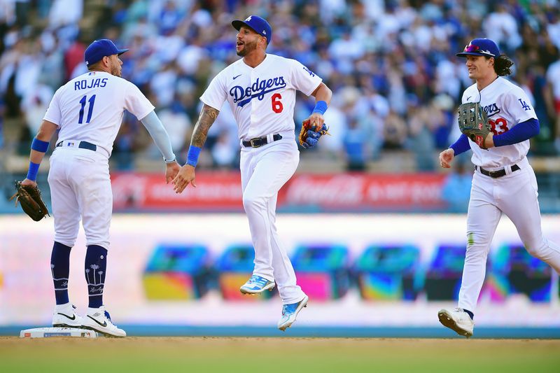 Jun 24, 2023; Los Angeles, California, USA; Los Angeles Dodgers shortstop Miguel Rojas (11) left fielder David Peralta (6) and center fielder James Outman (33) celebrate the victory against the Houston Astros at Dodger Stadium. Mandatory Credit: Gary A. Vasquez-USA TODAY Sports