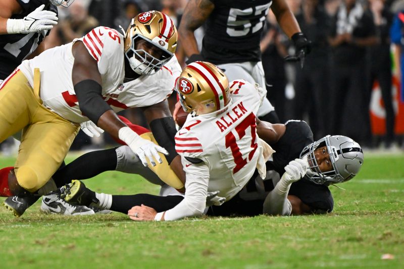 Las Vegas Raiders defensive end Charles Snowden, right, sacks San Francisco 49ers quarterback Brandon Allen during the first half of an NFL preseason football game, Friday, Aug. 23, 2024, in Las Vegas. (AP Photo/David Becker)