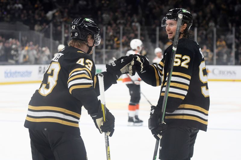 Mar 16, 2024; Boston, Massachusetts, USA; Boston Bruins left wing Danton Heinen (43) is congratulated by defenseman Andrew Peeke (52) after scoring a goal during the third period against the Philadelphia Flyers at TD Garden. Mandatory Credit: Bob DeChiara-USA TODAY Sports