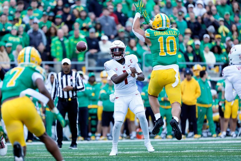 Oct 21, 2023; Eugene, Oregon, USA; Washington State Cougars quarterback Cameron Ward (1) throws a pass while under pressure from Oregon Ducks quarterback Bo Nix (10) during the first half at Autzen Stadium. Mandatory Credit: Soobum Im-USA TODAY Sports