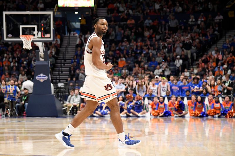 Mar 17, 2024; Nashville, TN, USA;  Auburn Tigers forward Chris Moore (5) reacts in the first half against the Florida Gators in the SEC Tournament championship game at Bridgestone Arena. Mandatory Credit: Steve Roberts-USA TODAY Sports