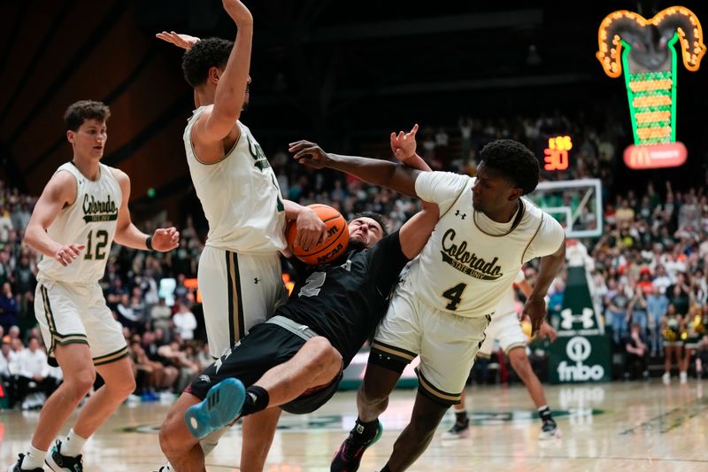 Feb 27, 2024; Fort Collins, Colorado, USA; Nevada Wolf Pack guard Jarod Lucas (2) goes down hard with Colorado State Rams forward Joel Scott (1) (left) and Colorado State Rams guard Isaiah Stevens (4) defending during the second half at Moby Arena. Mandatory Credit: Michael Madrid-USA TODAY Sports