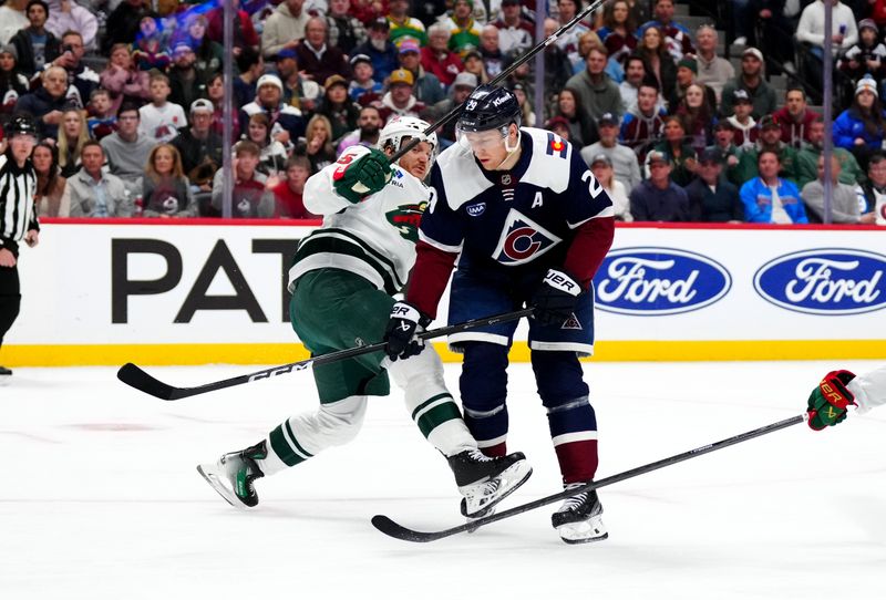 Feb 28, 2025; Denver, Colorado, USA; Minnesota Wild defenseman Jonas Brodin (25) defends on Colorado Avalanche center Nathan MacKinnon (29) in the second period at Ball Arena. Mandatory Credit: Ron Chenoy-Imagn Images