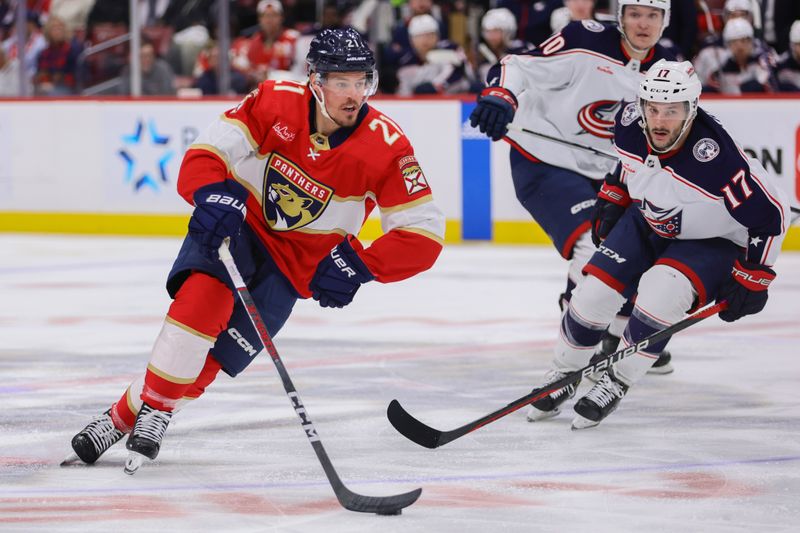 Apr 11, 2024; Sunrise, Florida, USA; Florida Panthers center Nick Cousins (21) moves the puck against the Columbus Blue Jackets during the second period at Amerant Bank Arena. Mandatory Credit: Sam Navarro-USA TODAY Sports