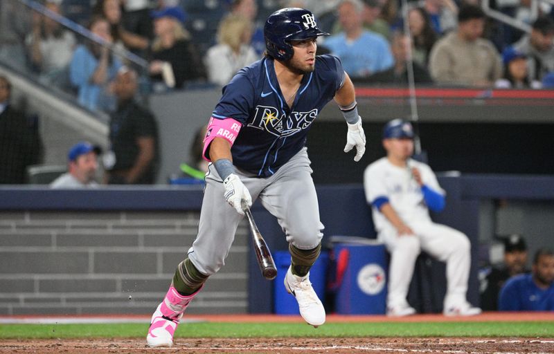 May 17, 2024; Toronto, Ontario, CAN;  Tampa Bay Rays designated hitter Jonathan Aranda (62) hits a single against the Toronto Blue Jays in the seventh inning at Rogers Centre. Mandatory Credit: Dan Hamilton-USA TODAY Sports