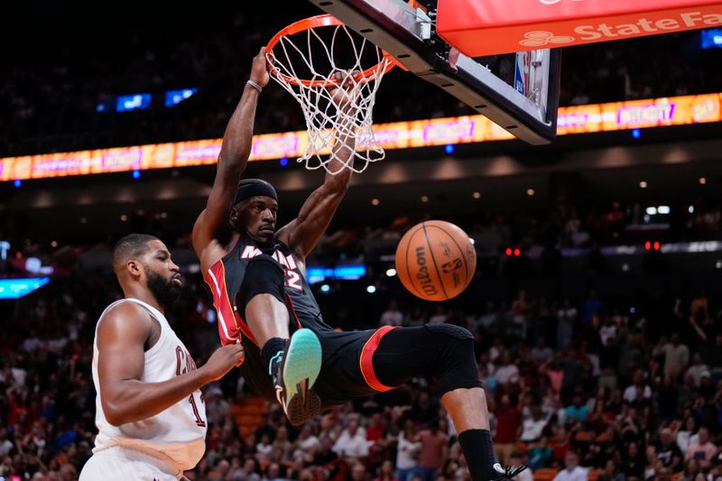 MIAMI, FLORIDA - MARCH 24: Jimmy Butler #22 of the Miami Heat dunks the ball over Tristan Thompson #13 of the Cleveland Cavaliers during the third quarter at Kaseya Center on March 24, 2024 in Miami, Florida. NOTE TO USER: User expressly acknowledges and agrees that, by downloading and or using this photograph, User is consenting to the terms and conditions of the Getty Images License Agreement. (Photo by Rich Storry/Getty Images)