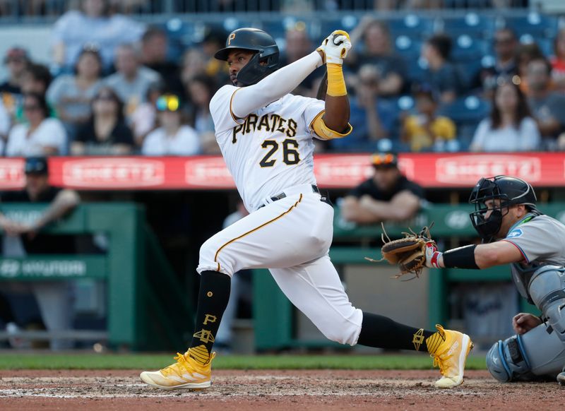 Oct 1, 2023; Pittsburgh, Pennsylvania, USA;  Pittsburgh Pirates right fielder Miguel Andujar (26) hits an RBI single against the Miami Marlins during the eighth inning at PNC Park. Pittsburgh won 3-0. Mandatory Credit: Charles LeClaire-USA TODAY Sports