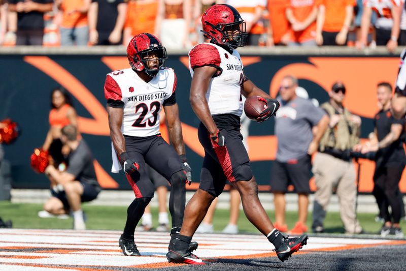 Sep 16, 2023; Corvallis, Oregon, USA; San Diego State Aztecs running back Jaylon Armstead (2) celebrates with Keenan Christon (23) after scoring a touchdown during the second half against the Oregon State Beavers at Reser Stadium. Mandatory Credit: Soobum Im-USA TODAY Sports