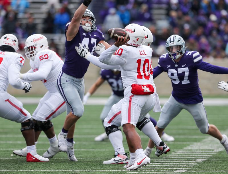 Oct 28, 2023; Manhattan, Kansas, USA; Houston Cougars quarterback Ui Ale (10) tries to pass against Kansas State Wildcats defensive end Cody Stufflebean (47) during the fourth quarter at Bill Snyder Family Football Stadium. Mandatory Credit: Scott Sewell-USA TODAY Sports